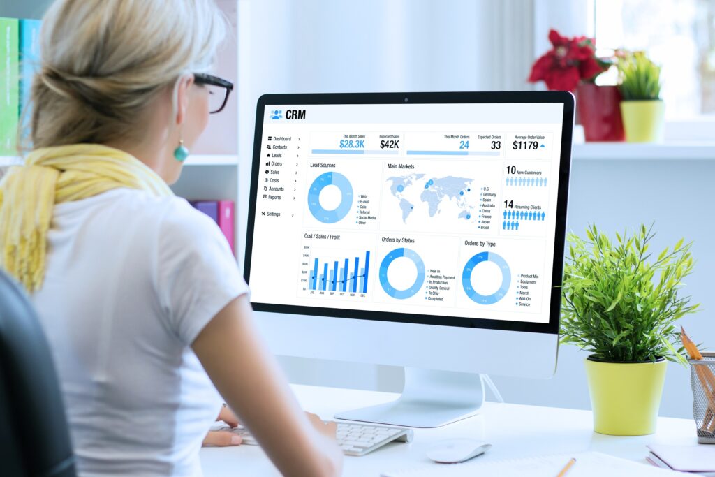 Woman,Working,In,Office,With,A,Computer,With,Different,Graphs,